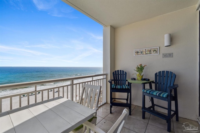 balcony with a water view and a beach view