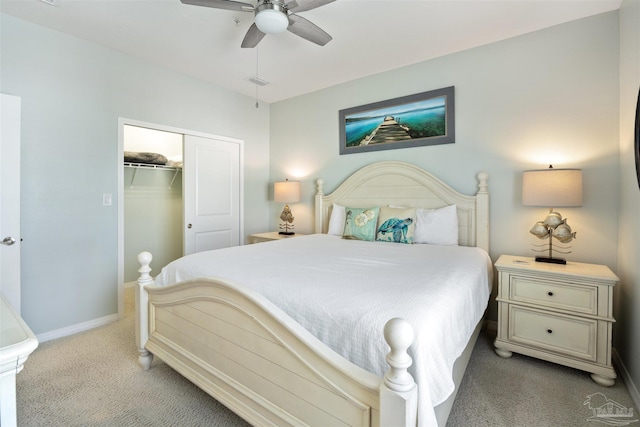 bedroom featuring ceiling fan, a closet, and light colored carpet