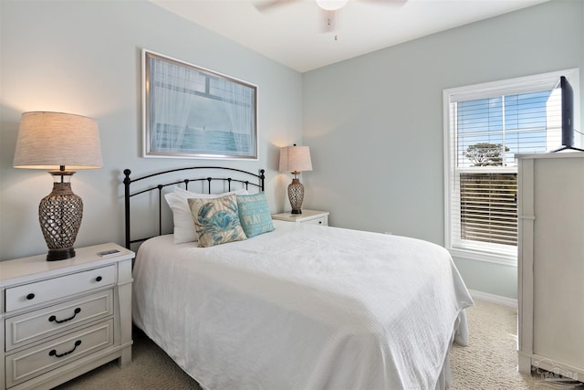 bedroom featuring light carpet and ceiling fan