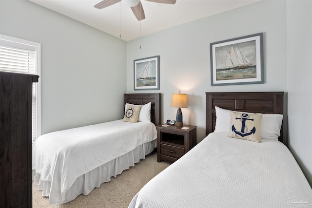 bedroom with ceiling fan and light carpet