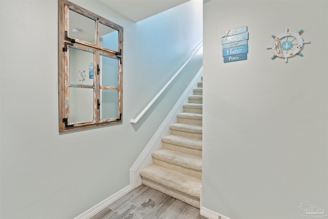 stairway with hardwood / wood-style floors