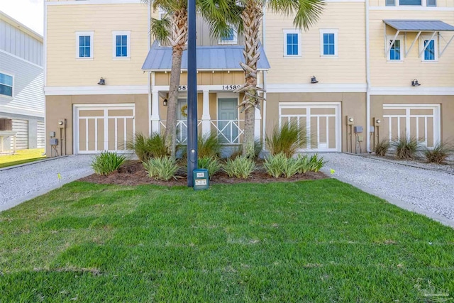 view of property with a garage and a front lawn