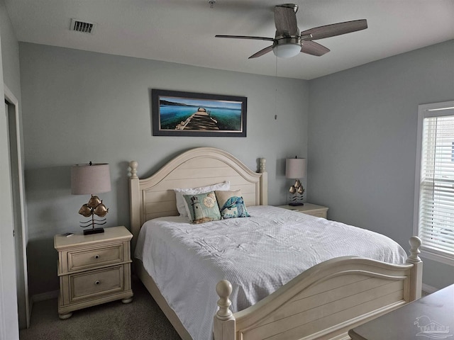 bedroom with dark colored carpet and ceiling fan