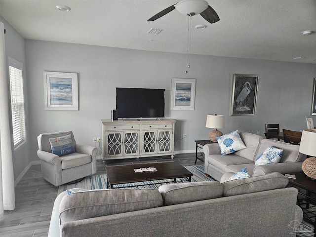 living room with light hardwood / wood-style flooring and ceiling fan