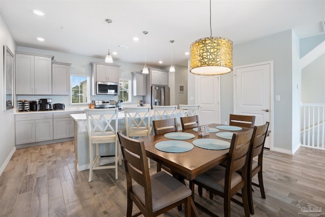 dining space with light hardwood / wood-style floors