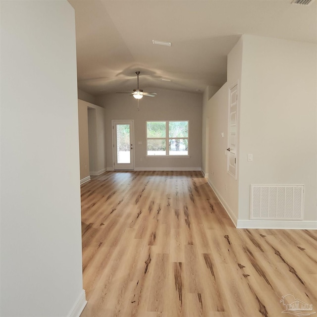 empty room with ceiling fan, light hardwood / wood-style floors, and lofted ceiling