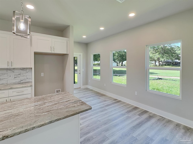 5773 Trevino Dr, Milton, FL 32570 - kitchen featuring recessed lighting, white cabinetry, backsplash, light wood finished floors, and light stone countertops