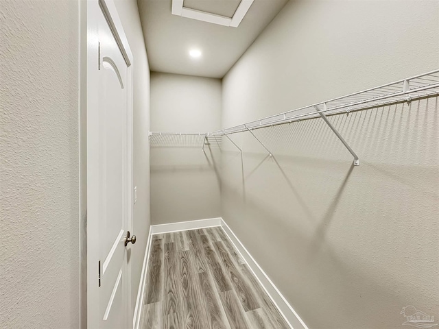 5773 Trevino Dr, Milton, FL 32570 - walk in closet featuring wood finished floors and attic access