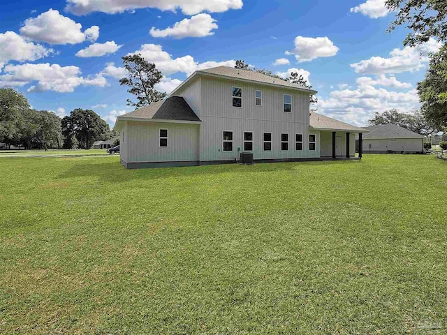 5773 Trevino Dr, Milton, FL 32570 - rear view of house featuring a lawn, central air condition unit, and roof with shingles