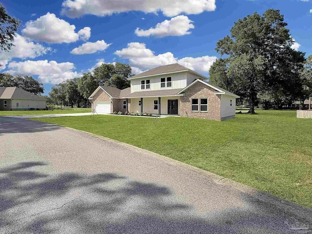 5773 Trevino Dr, Milton, FL 32570 - view of front of home with concrete driveway, a front yard, an attached garage, and covered porch