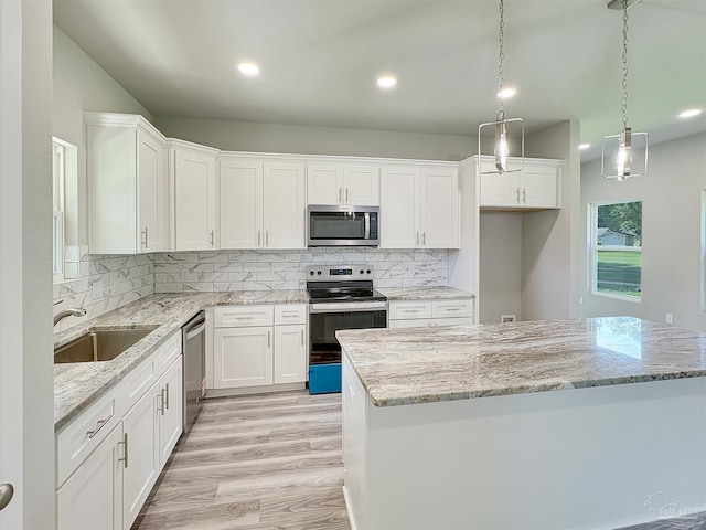 5773 Trevino Dr, Milton, FL 32570 - kitchen featuring appliances with stainless steel finishes, a sink, white cabinets, light wood-style floors, and recessed lighting
