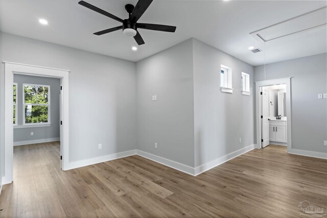 9616 Indian Stone Ct Lot 8, Navarre, FL 32566 - empty room with attic access, a healthy amount of sunlight, wood finished floors, and visible vents