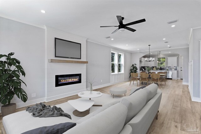9616 Indian Stone Ct Lot 8, Navarre, FL 32566 - living room featuring a fireplace, visible vents, recessed lighting, and crown molding