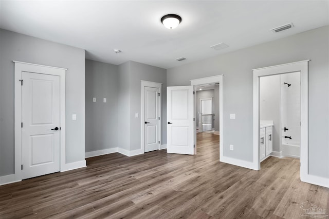 9616 Indian Stone Ct Lot 8, Navarre, FL 32566 - unfurnished bedroom with wood finished floors, visible vents, baseboards, and ensuite bathroom