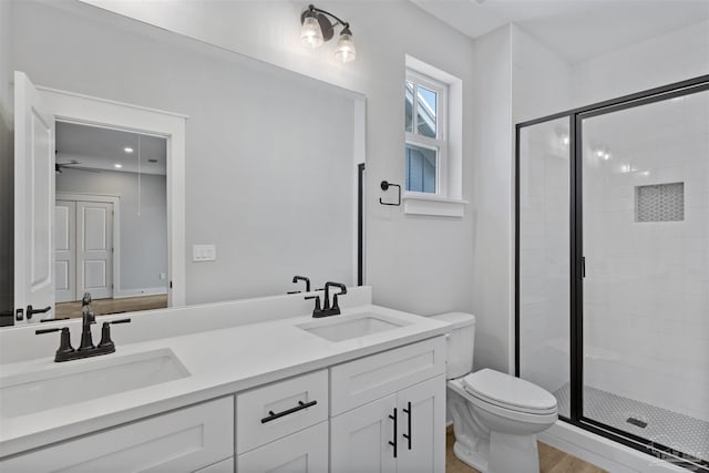 9616 Indian Stone Ct Lot 8, Navarre, FL 32566 - full bathroom with double vanity, toilet, a stall shower, and a sink