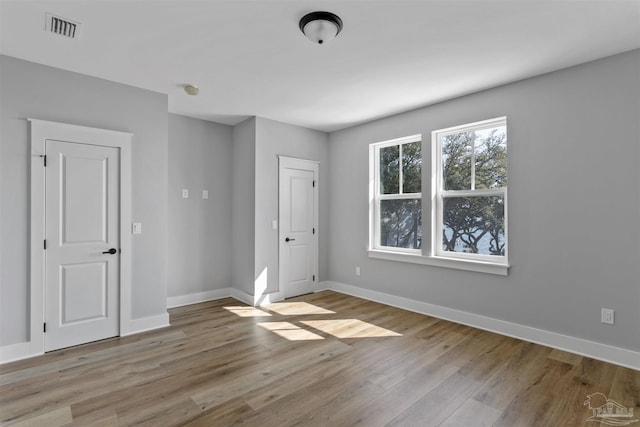 9616 Indian Stone Ct Lot 8, Navarre, FL 32566 - unfurnished room with wood finished floors, visible vents, and baseboards
