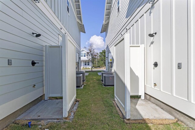 9616 Indian Stone Ct Lot 8, Navarre, FL 32566 - view of side of home with board and batten siding, a yard, and cooling unit