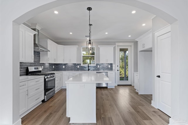 9616 Indian Stone Ct Lot 8, Navarre, FL 32566 - kitchen with stainless steel appliances, light countertops, wall chimney range hood, a sink, and tasteful backsplash