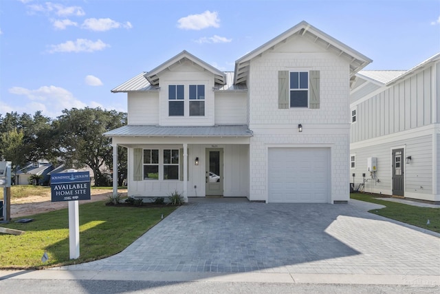 9616 Indian Stone Ct Lot 8, Navarre, FL 32566 - view of front of home featuring a garage, driveway, a front lawn, and metal roof