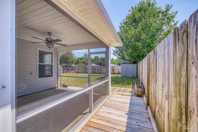 unfurnished sunroom featuring ceiling fan