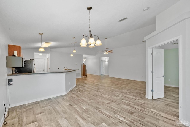 kitchen featuring stainless steel fridge, ceiling fan, light hardwood / wood-style flooring, lofted ceiling, and hanging light fixtures