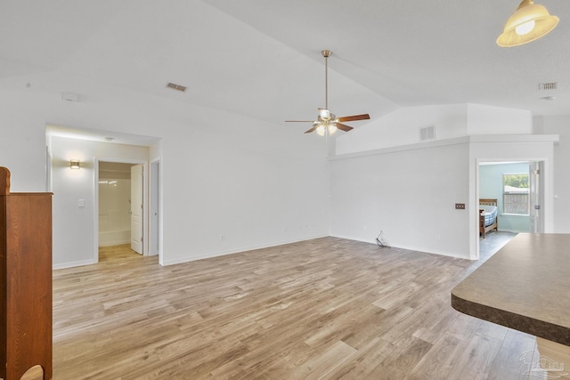 unfurnished living room featuring lofted ceiling, ceiling fan, and light hardwood / wood-style flooring