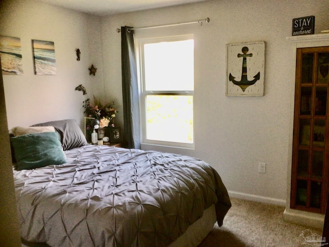 bedroom featuring multiple windows and carpet flooring