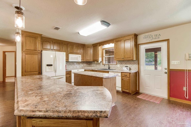 8206 Chumuckla Hwy, Pace, FL 32571 - kitchen featuring white appliances, dark wood finished floors, a kitchen island, decorative backsplash, and a sink