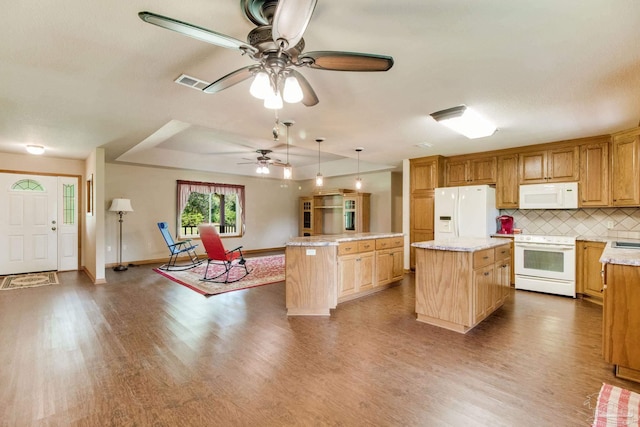8206 Chumuckla Hwy, Pace, FL 32571 - kitchen featuring white appliances, a kitchen island, wood finished floors, ceiling fan, and backsplash