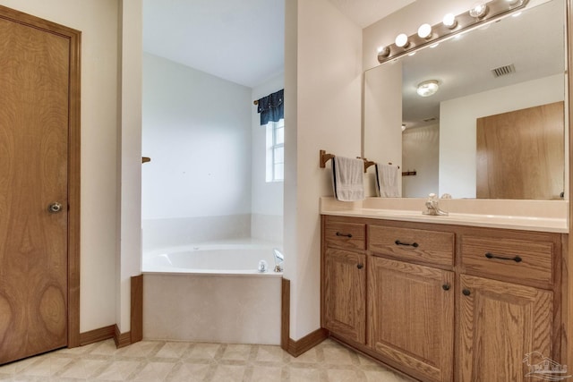 8206 Chumuckla Hwy, Pace, FL 32571 - bathroom with baseboards, a bath, tile patterned floors, vanity, and vaulted ceiling
