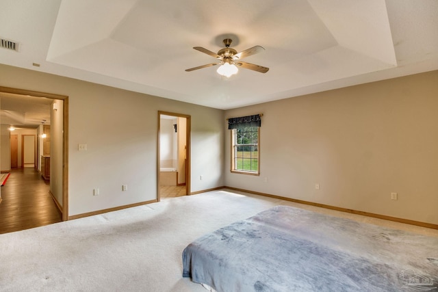 8206 Chumuckla Hwy, Pace, FL 32571 - unfurnished bedroom featuring carpet, baseboards, ensuite bathroom, and a raised ceiling