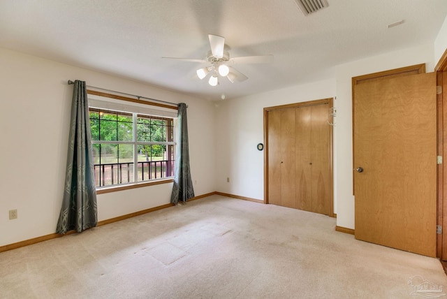 8206 Chumuckla Hwy, Pace, FL 32571 - unfurnished bedroom featuring light carpet, a closet, baseboards, and a ceiling fan