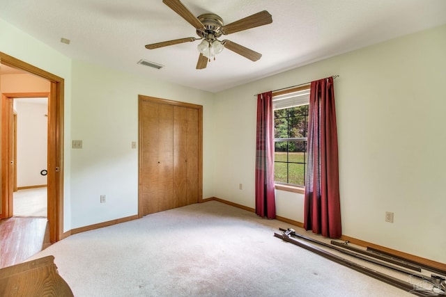 8206 Chumuckla Hwy, Pace, FL 32571 - unfurnished bedroom with a closet, baseboards, carpet floors, and ceiling fan