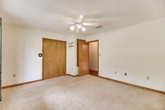 8206 Chumuckla Hwy, Pace, FL 32571 - unfurnished bedroom featuring light carpet, baseboards, a ceiling fan, and a closet