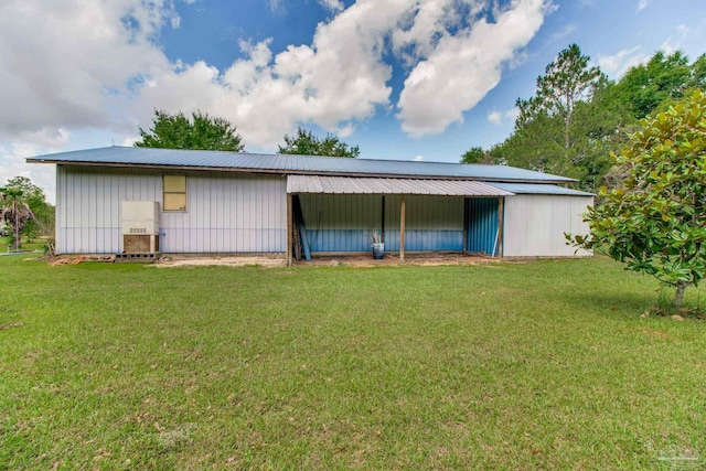 8206 Chumuckla Hwy, Pace, FL 32571 - back of house featuring a lawn, an outbuilding, metal roof, and an outdoor structure