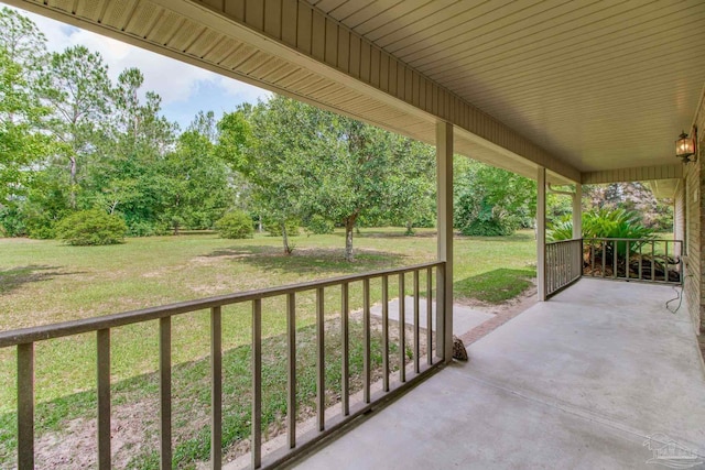8206 Chumuckla Hwy, Pace, FL 32571 - covered porch with a yard and view of wooded area