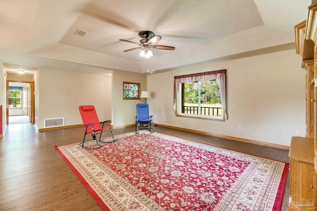 8206 Chumuckla Hwy, Pace, FL 32571 - living area with a raised ceiling, ceiling fan, baseboards, and wood finished floors