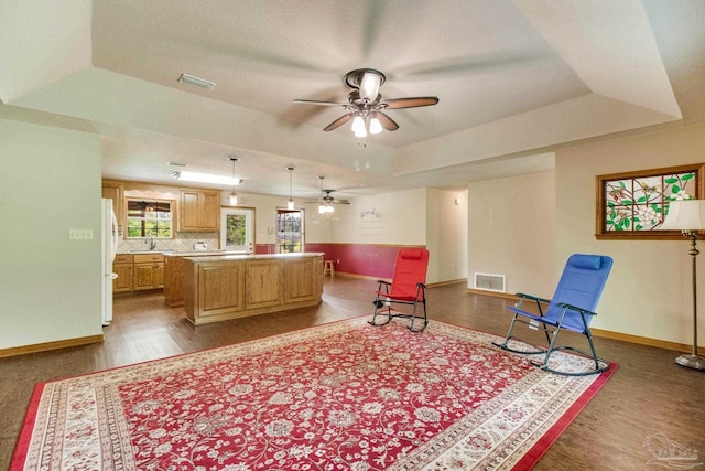 8206 Chumuckla Hwy, Pace, FL 32571 - living area featuring ceiling fan, a tray ceiling, dark wood finished floors, and baseboards