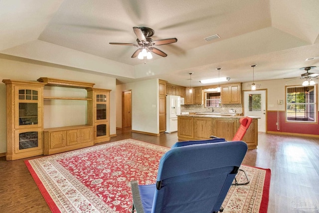 8206 Chumuckla Hwy, Pace, FL 32571 - living area with ceiling fan, a raised ceiling, wood finished floors, and baseboards