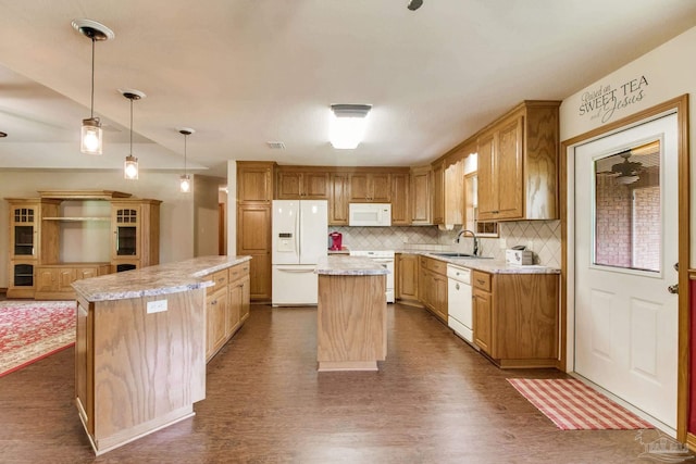 8206 Chumuckla Hwy, Pace, FL 32571 - kitchen with white appliances, a kitchen island, a sink, tasteful backsplash, and dark wood-type flooring