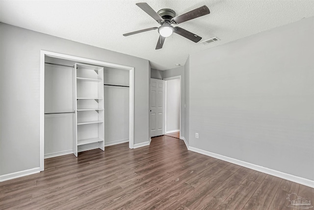 5773 Michael Dr, Milton, FL 32583 - unfurnished bedroom with wood finished floors, a textured ceiling, a closet, baseboards, and a ceiling fan