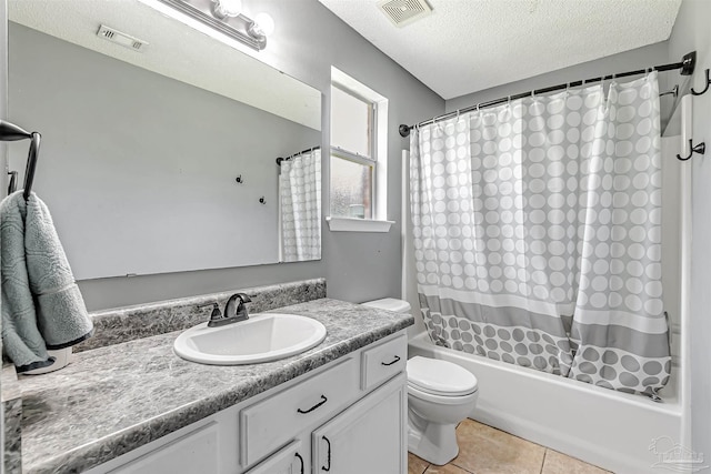5773 Michael Dr, Milton, FL 32583 - bathroom with a textured ceiling, toilet, vanity, shower / tub combo with curtain, and tile patterned floors