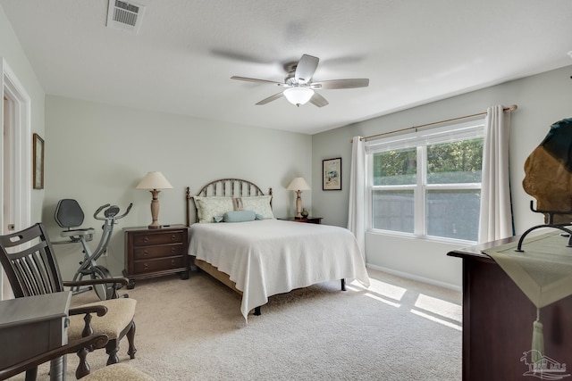 bedroom featuring visible vents, baseboards, a ceiling fan, and carpet flooring