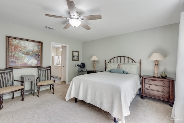 bedroom featuring visible vents, a ceiling fan, light colored carpet, and connected bathroom