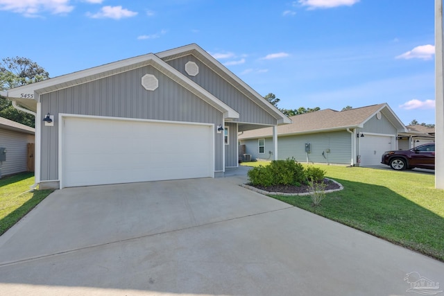 single story home featuring concrete driveway, a front lawn, and a garage