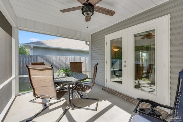 sunroom featuring ceiling fan, outdoor dining area, and french doors