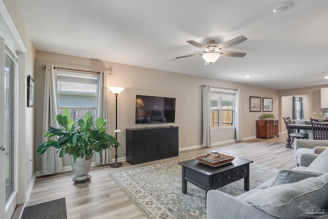 living area featuring light wood-style flooring, baseboards, recessed lighting, and ceiling fan