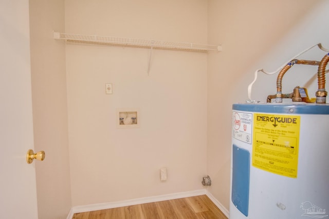 washroom featuring hookup for a washing machine, electric water heater, hardwood / wood-style floors, and hookup for an electric dryer