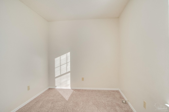 unfurnished room featuring light colored carpet