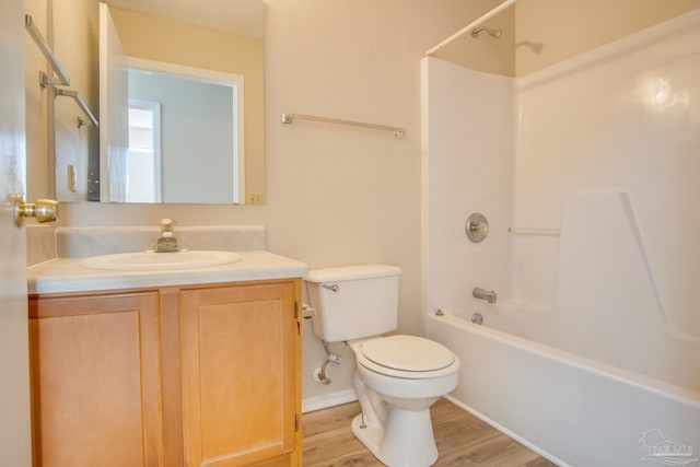 full bathroom with wood-type flooring, vanity, toilet, and shower / washtub combination